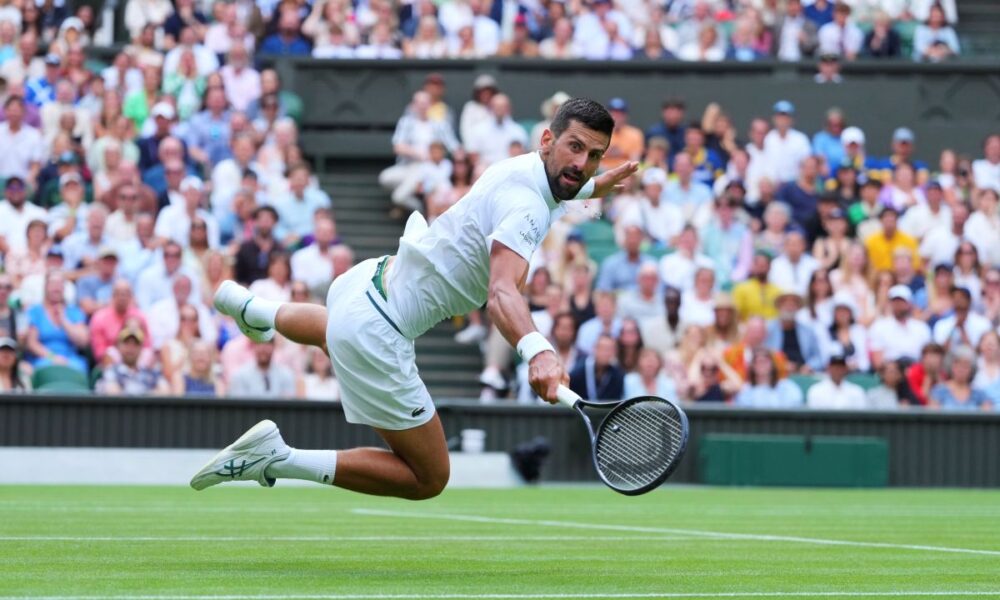 Novak Djokovic of Serbia dives to return to Miomir Kecmanovic of Serbia during a third round men's singles match at the Wimbledon Tennis Championships in London, Saturday, July 5, 2025. (AP Photo/Kirsty Wigglesworth)