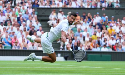 Novak Djokovic of Serbia dives to return to Miomir Kecmanovic of Serbia during a third round men's singles match at the Wimbledon Tennis Championships in London, Saturday, July 5, 2025. (AP Photo/Kirsty Wigglesworth)