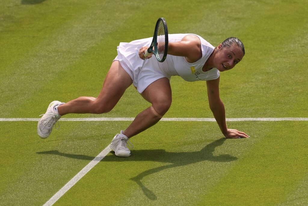 Elisabetta Cocciaretto of Italy gets up after falling during her women's first round singles match against Jessica Pegula of the U.S. at the Wimbledon Tennis Championships in London, Tuesday, July 1, 2025.(AP Photo/Joanna Chan)
