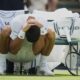 Novak Djokovic of Serbia stretches during a change of ends break as he plays Daniel Evans of Britain during their second round men's singles match at the Wimbledon Tennis Championships in London, Thursday, July 3, 2025. (AP Photo/Alastair Grant)