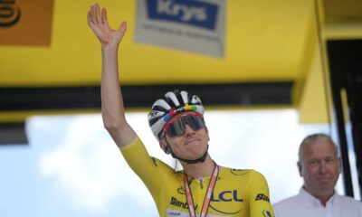 Slovenia's Tadej Pogacar, wearing the overall leader's yellow jersey, greets spectators prior to the start of the nineteenth stage of the Tour de France cycling race over 93.1 kilometers (57.85 miles) with start in Albertville and finish in La Plagne, France, Friday, July 25, 2025. (AP Photo/Mosa'ab Elshamy)