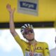 Slovenia's Tadej Pogacar, wearing the overall leader's yellow jersey, greets spectators prior to the start of the nineteenth stage of the Tour de France cycling race over 93.1 kilometers (57.85 miles) with start in Albertville and finish in La Plagne, France, Friday, July 25, 2025. (AP Photo/Mosa'ab Elshamy)