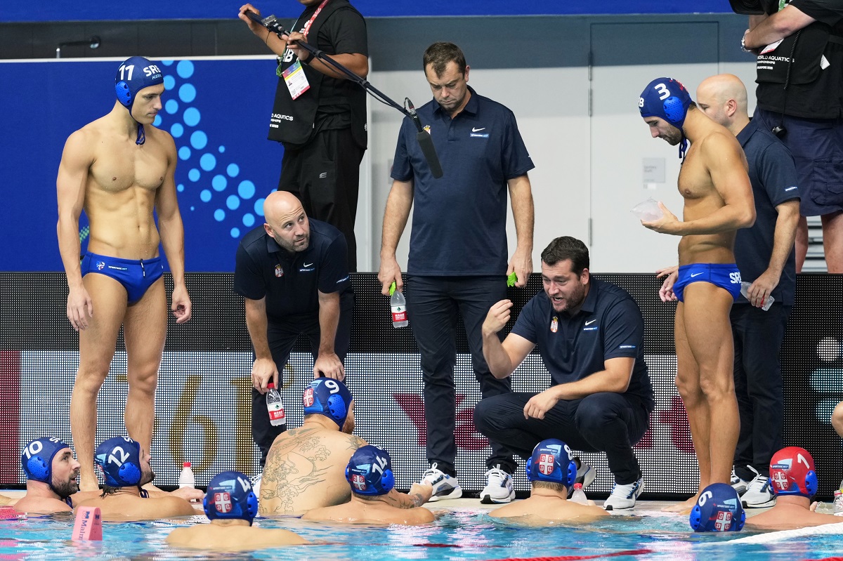Serbia's head coach Uros Stevanovic talks to his players during the men's water polo bronze medal match against Greece at the World Aquatics Championships in Singapore, Thursday, July 24, 2025. (AP Photo/Vincent Thian)