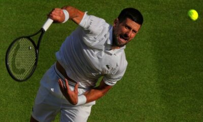 Serbia's Novak Djokovic serves to Italy's Flavio Cobolli during a quarterfinal men's singles match at the Wimbledon Tennis Championships in London, Wednesday, July 9, 2025. (AP Photo/Joanna Chan)