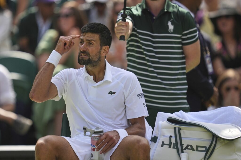 Serbia's Novak Djokovic gestures during a change of ends break against Australia's Alex de Minaur during a fourth round men's singles match at the Wimbledon Tennis Championships in London, Monday, July 7, 2025. (AP Photo/Kin Cheung)