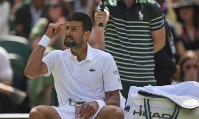 Serbia's Novak Djokovic gestures during a change of ends break against Australia's Alex de Minaur during a fourth round men's singles match at the Wimbledon Tennis Championships in London, Monday, July 7, 2025. (AP Photo/Kin Cheung)