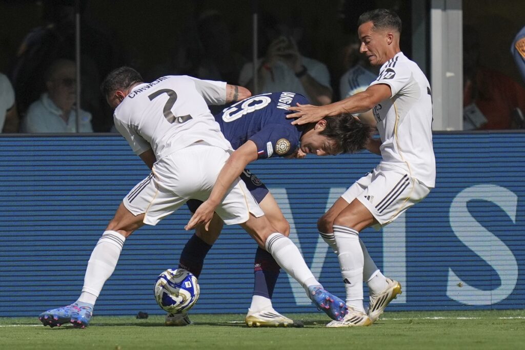 Paris Saint-Germain's Lee Kang-in (19), Real Madrid's Dani Carvajal (2) and Lucas Vazquez (17) battle for the ball during the Club World Cup semifinal soccer match between PSG and Real Madrid in East Rutherford, N.J., Wednesday, July 9, 2025. (AP Photo/Seth Wenig)