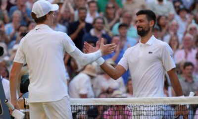 Italy's Jannik Sinner, left, greets Serbia's Novak Djokovic after winning their men's singles semifinal at the Wimbledon Tennis Championships in London, Friday, July 11, 2025. (AP Photo/Kin Cheung)