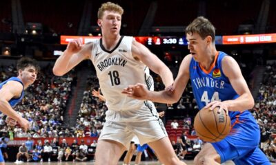 Oklahoma City Thunder guard Nikola Topić (44) drives the ball against Brooklyn Nets forward Danny Wolf (18) during the first half of an NBA summer league basketball game Thursday, July 10, 2025, in Las Vegas. (AP Photo/David Becker)