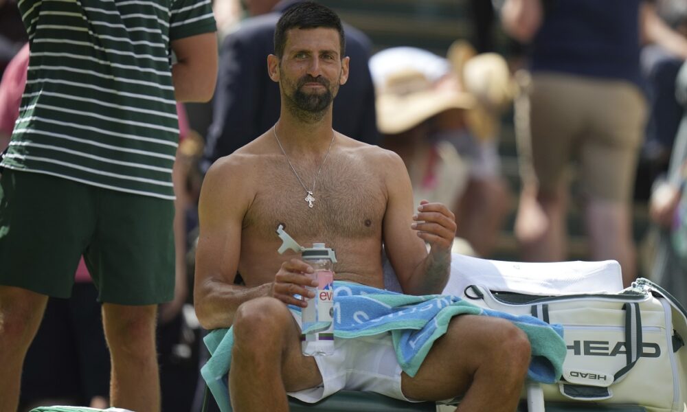 Novak Djokovic of Serbia sits in his chair during a change of ends break as he plays Daniel Evans of Britain during their second round men's singles match at the Wimbledon Tennis Championships in London, Thursday, July 3, 2025. (AP Photo/Alastair Grant)