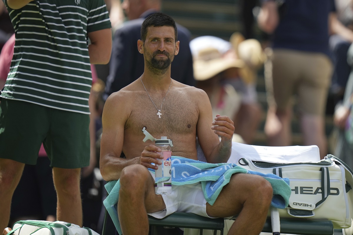 Novak Djokovic of Serbia sits in his chair during a change of ends break as he plays Daniel Evans of Britain during their second round men's singles match at the Wimbledon Tennis Championships in London, Thursday, July 3, 2025. (AP Photo/Alastair Grant)
