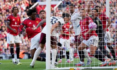 Arsenal's Riccardo Calafiori scores his sides first goal during the English Premier League soccer match between Manchester United and Arsenal at Old Trafford stadium in Manchester, England, Sunday, Aug. 17, 2025. (AP Photo/Dave Thompson)