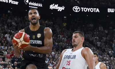 Germany's Johannes Thiemann, left, drives to the basket past Serbia's Nikola Jokic during the final of the Supercup basketball tournament, Saturday, Aug. 16, 2025, in Munich, Germany. (Sven Hoppe/dpa via AP)