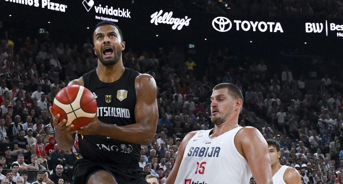 Germany's Johannes Thiemann, left, drives to the basket past Serbia's Nikola Jokic during the final of the Supercup basketball tournament, Saturday, Aug. 16, 2025, in Munich, Germany. (Sven Hoppe/dpa via AP)