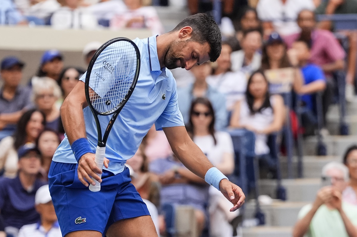 Novak Djokovic, of Serbia, reacts during a mixed doubles match at the U.S. Open tennis championships, Tuesday, Aug. 19, 2025, in New York. (AP Photo/Yuki Iwamura)