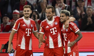 Bayern Munich's Harry Kane, center, celebrates scoring during the Bundesliga soccer match between Bayern Munich and RB Leipzig at Allianz Arena, Munich, Germany, Friday Aug. 22, 2025. (Sven Hoppe/dpa via AP)