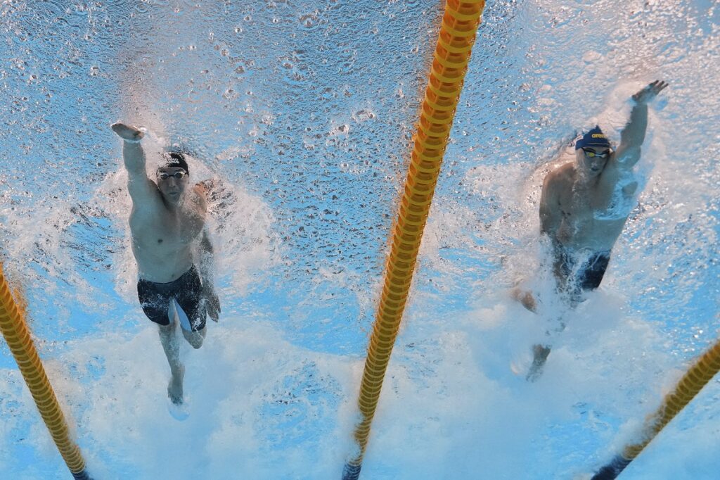 Neutral Athlete Russia, Egor Kornev and Andrej Barna of Serbia compete in the men's 50-meter freestyle semifinals at the World Aquatics Championships in Singapore, Friday, Aug. 1, 2025. (AP Photo/Lee Jin-man)