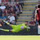 Bournemouth goalkeeper Djordje Petrovic, left, saves Real Sociedad's Mikel Oyarzabal's, not pictured, penalty kick during a pre-season friendly soccer match between Bournemouth and Real Sociedad at Vitality Stadium, Bournemouth, England, Saturday Aug. 9, 2025. (Andrew Matthews/PA via AP)