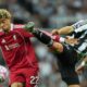 Liverpool's Hugo Ekitike, left, and Newcastle's Fabian Schaer fight for the ball during the Premier League soccer match between Newcastle and Liverpool in Newcastle, England, Monday, Aug. 25, 2025. (AP Photo/Jon Super)