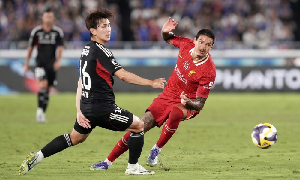 Liverpool's Darwin Nunez, right, and Marinos' Ren Kato battle for control of the ball during a friendly soccer match between Yokohama F. Marinos and Liverpool F.C. at Nissan Stadium in Yokohama, Japan, Wednesday, July 30, 2025. (AP Photo/Eugene Hoshiko)