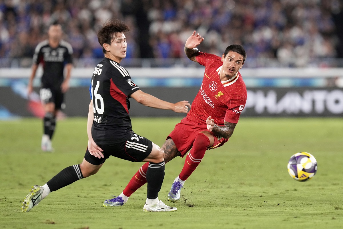 Liverpool's Darwin Nunez, right, and Marinos' Ren Kato battle for control of the ball during a friendly soccer match between Yokohama F. Marinos and Liverpool F.C. at Nissan Stadium in Yokohama, Japan, Wednesday, July 30, 2025. (AP Photo/Eugene Hoshiko)