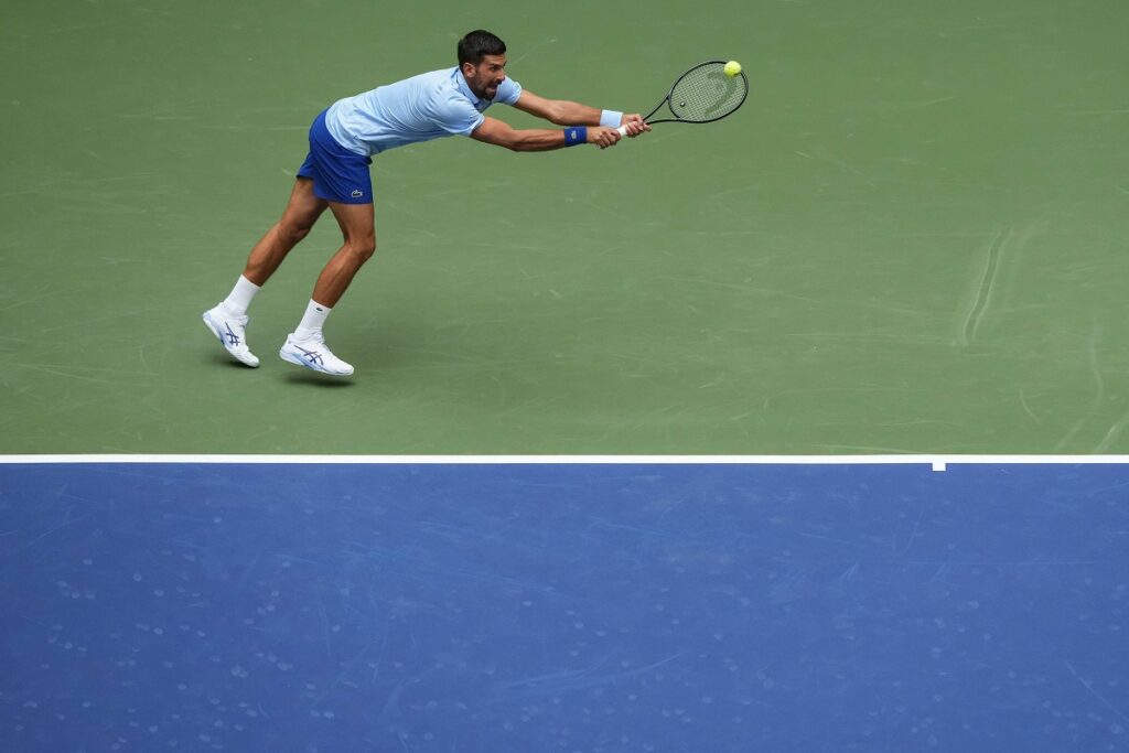Novak Djokovic, of Serbia, returns a shot during a mixed doubles match at the U.S. Open tennis championships, Tuesday, Aug. 19, 2025, in New York. (AP Photo/Yuki Iwamura)