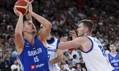 Serbia's Nikola Jokic, left, and Czech Republic's Martin Peterka in action during the Basketball Supercup semifinal between Serbia and Czech Republic, in the SAP Garden, Munich, Germany, Friday Aug. 15, 2025. (Sven Hoppe/dpa via AP)