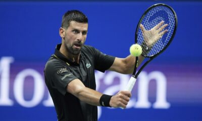 Novak Djokovic, of Serbia, returns a shot to Learner Tien, of the United States, during the first-round of the U.S. Open tennis championships, Sunday, Aug. 24, 2025, in New York. (AP Photo/Frank Franklin II)