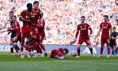 Liverpool's Harvey Elliott on the floor behind the wall during a free kick during the pre-season friendly soccer match between Liverpool and Athletic Bilbao, at Anfield, Liverpool, England, Monday Aug. 4, 2025. (Peter Byrne/PA via AP)