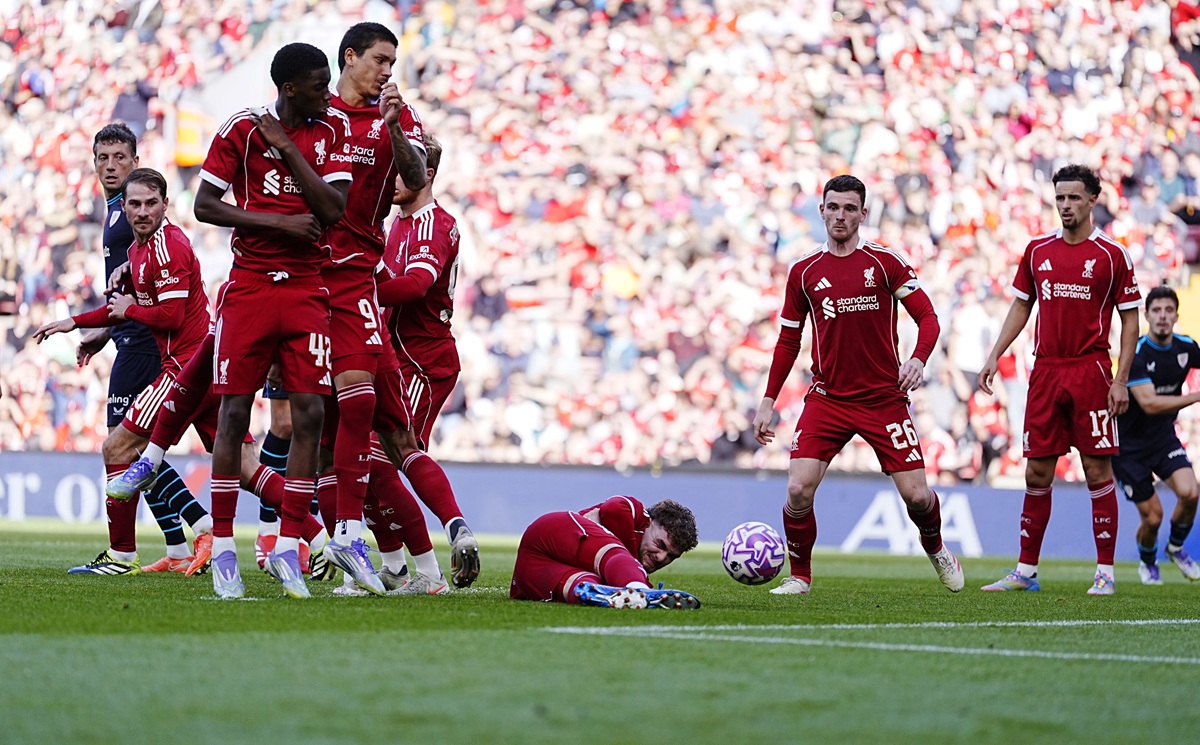 Liverpool's Harvey Elliott on the floor behind the wall during a free kick during the pre-season friendly soccer match between Liverpool and Athletic Bilbao, at Anfield, Liverpool, England, Monday Aug. 4, 2025. (Peter Byrne/PA via AP)