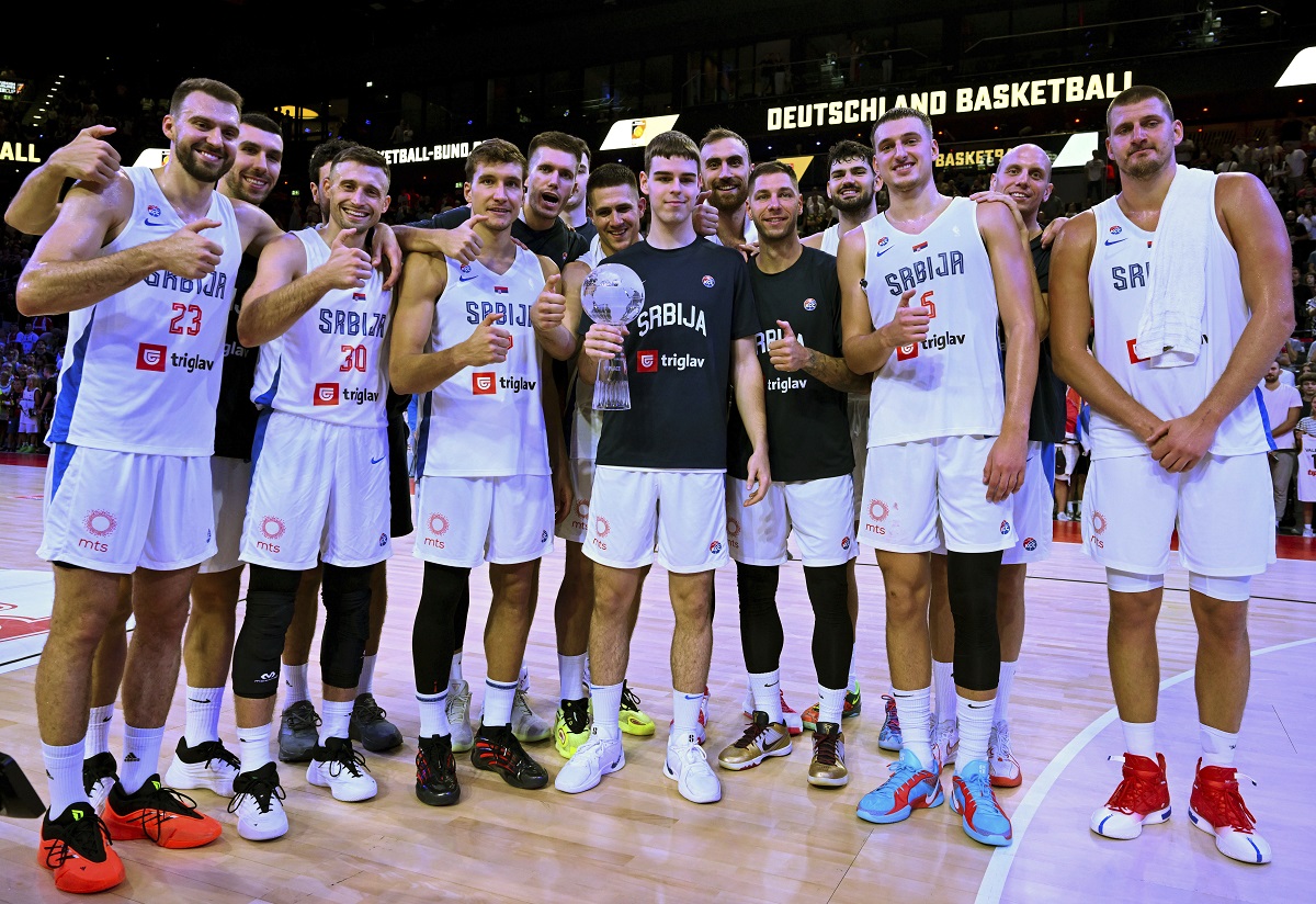 Serbia players pose with the trophy after defeating Germany in the final of the Supercup basketball tournament, Saturday, Aug. 16, 2025, in Munich, Germany. (Sven Hoppe/dpa via AP)