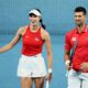 FILE - Novak Djokovic and Olga Danilovic of Serbia laugh on court during their mixed doubles match against Qinwen Zheng and Zhizhen Zhang of China during the United Cup tennis tournament in Perth, Australia, Sunday, Dec. 31, 2023. (AP Photo/Trevor Collens)