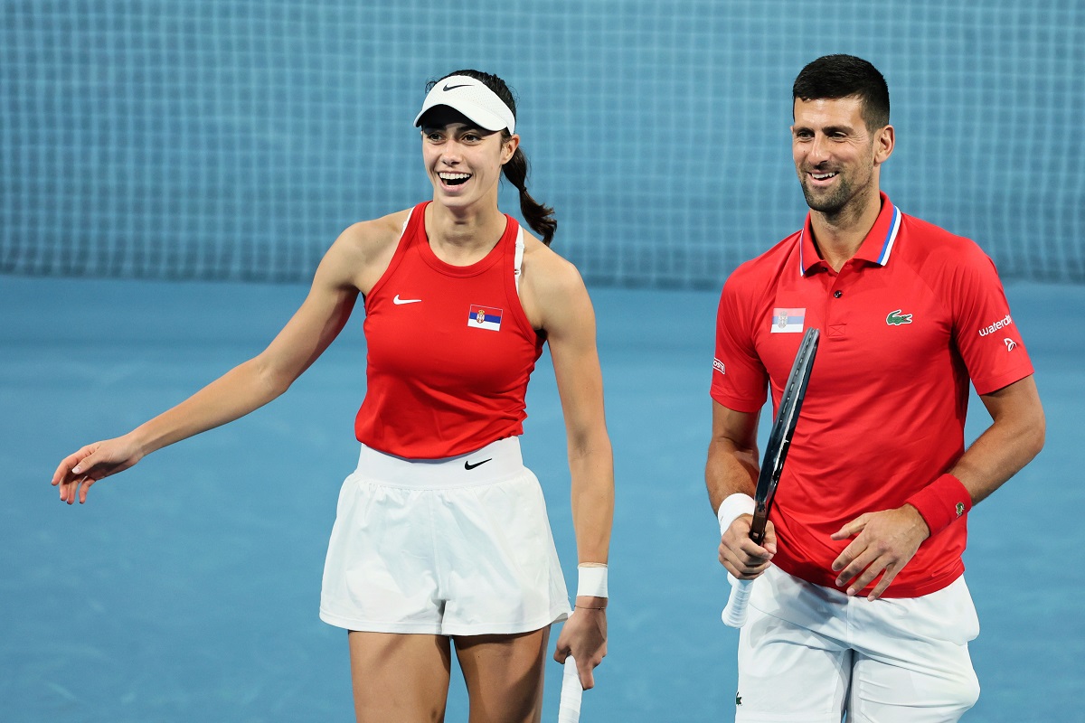 FILE - Novak Djokovic and Olga Danilovic of Serbia laugh on court during their mixed doubles match against Qinwen Zheng and Zhizhen Zhang of China during the United Cup tennis tournament in Perth, Australia, Sunday, Dec. 31, 2023. (AP Photo/Trevor Collens)