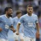 Malmö's Sead Hakšabanović, left, celebrates after scoring a goal during the Champions League qualifying round soccer match between Sweden's Malmö FF and Latvia's RFS, Wednesday, July 30, 2025, in Malmö, Sweden,. (Andreas Hillergren/TT News Agency via AP)