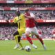 Arsenal's Viktor Gyokeres, right, and Villarreal's Pape Gueye battle for the ball during the Emirates Cup match at the Emirates Stadium, London, Wednesday Aug. 6, 2025. (John Walton/PA via AP)